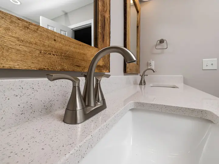 Bathroom vanity with a brushed nickel faucet