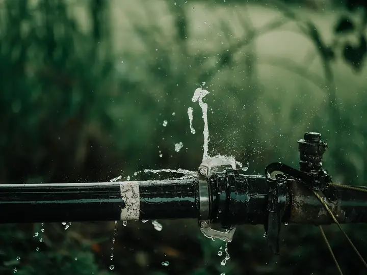 Water spraying from a burst black water pipe